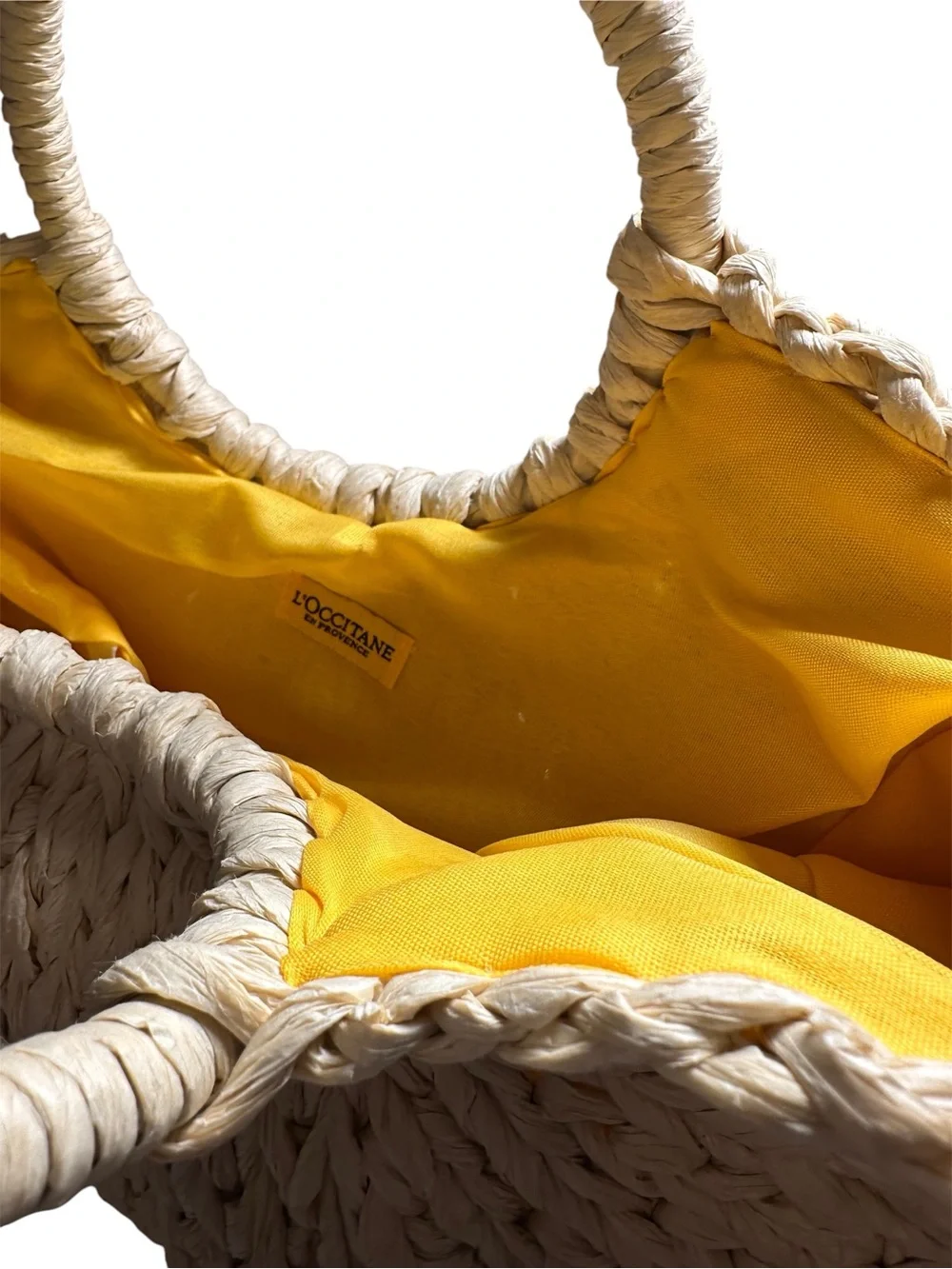 L’OCCITANE STRAW TOTE BAG WITH BRIGHT YELLOW LINING.